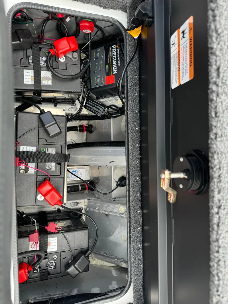 Slide: The Image of 2025 Vexus AVX1980 boat battery compartment with wiring and components. - 33