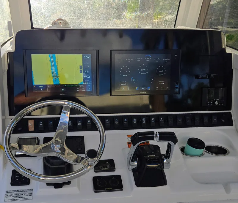 Slide: The Image of 2018 Sea Hunt Gamefish 30 dashboard with Garmin displays and steering wheel. - 1