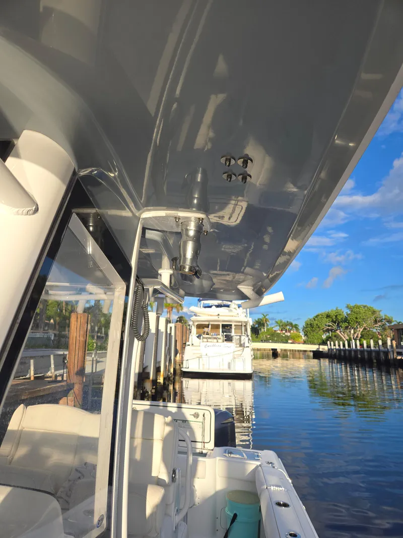 Slide: The Image of 2018 Sea Hunt Gamefish 30 boat docked, showcasing sleek design and forward seating. - 2