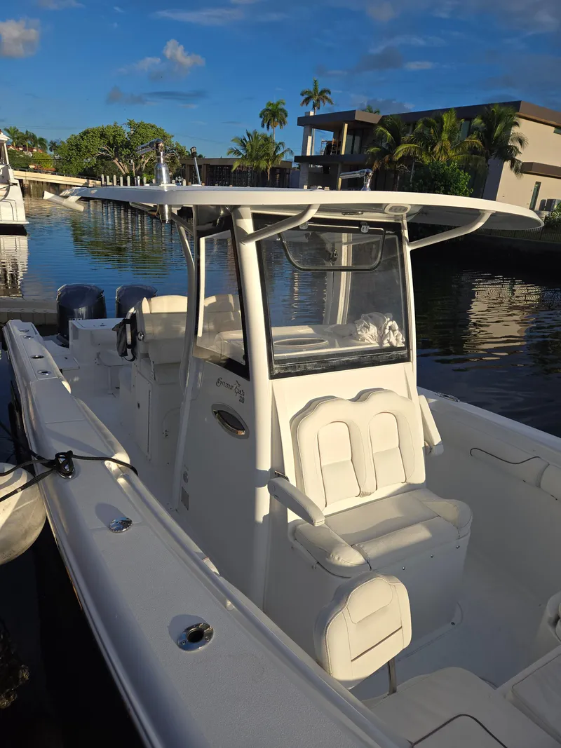 Slide: The Image of 2018 Sea Hunt Gamefish 30 boat docked, featuring forward seating and sleek design. - 4