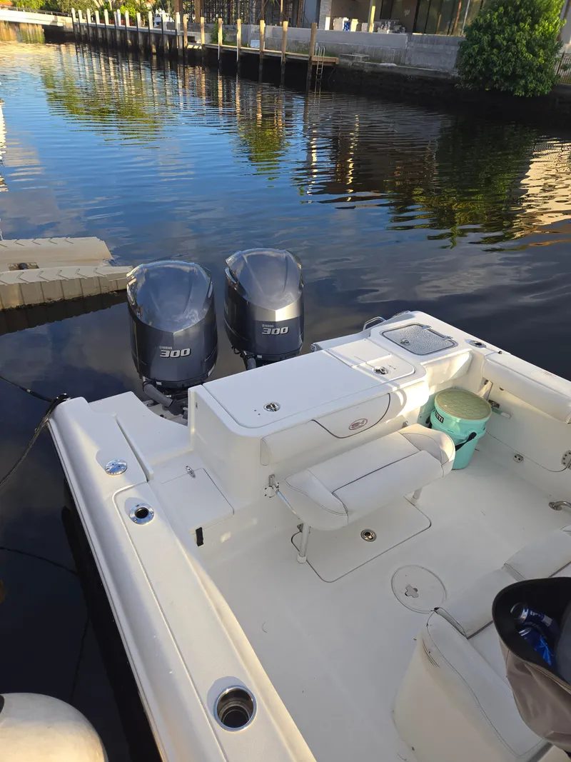Slide: The Image of 2018 Sea Hunt Gamefish 30 boat with twin 300 engines docked by calm waters. - 5