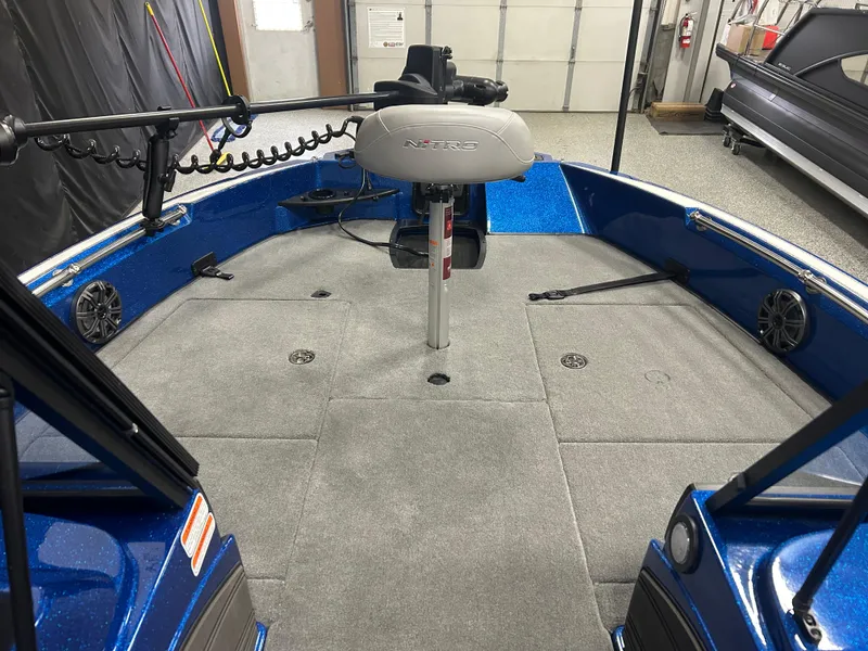 Slide: The Image of 2025 Nitro ZV20 boat interior with gray carpet and mounted equipment. - 17