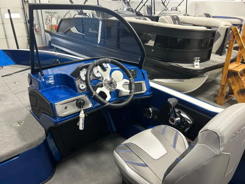 Slide: The Image of 2025 Nitro ZV20 boat interior with steering wheel and seating, showcasing modern design. - 18