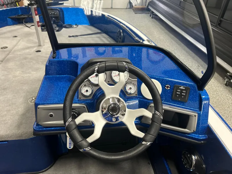 Slide: The Image of Steering wheel of a 2025 Nitro ZV20 boat, featuring a sleek blue dashboard design. - 19