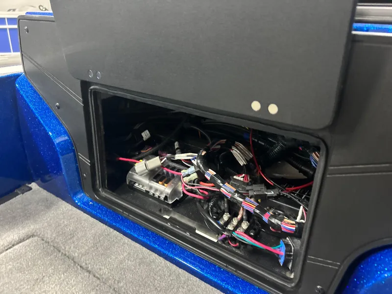 Slide: The Image of Open electrical compartment in 2025 Nitro ZV20 boat, showing wiring and connectors. - 21