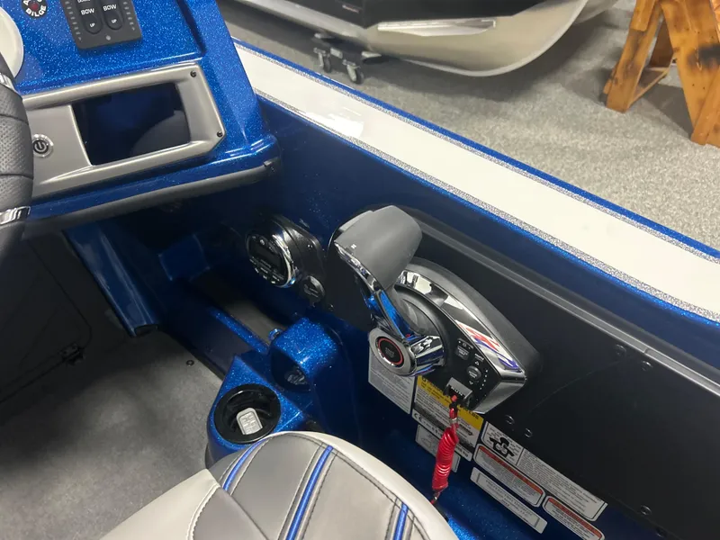Slide: The Image of Interior of 2025 Nitro ZV20 boat with control panel and throttle lever. - 26