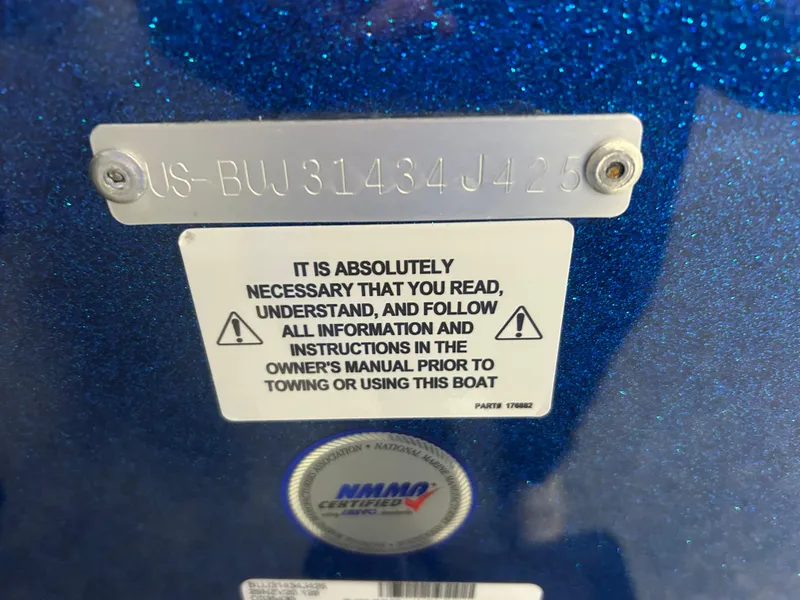 Slide: The Image of 2025 Nitro ZV20 boat warning label and identification plate on blue surface. - 30