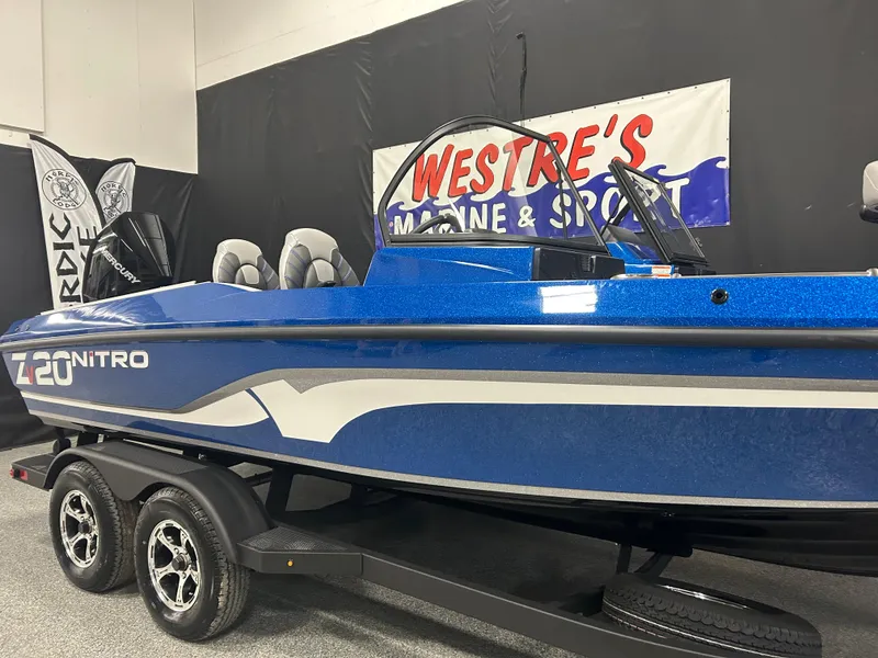 Slide: The Image of 2025 Nitro ZV20 boat in showroom, blue exterior, displayed on trailer. - 4