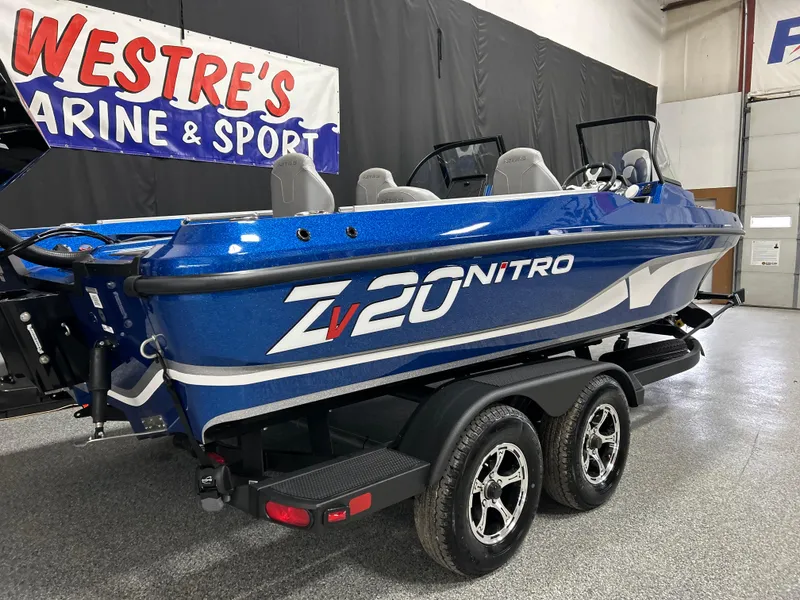 Slide: The Image of 2025 Nitro ZV20 boat in showroom, blue color, on a trailer. - 5