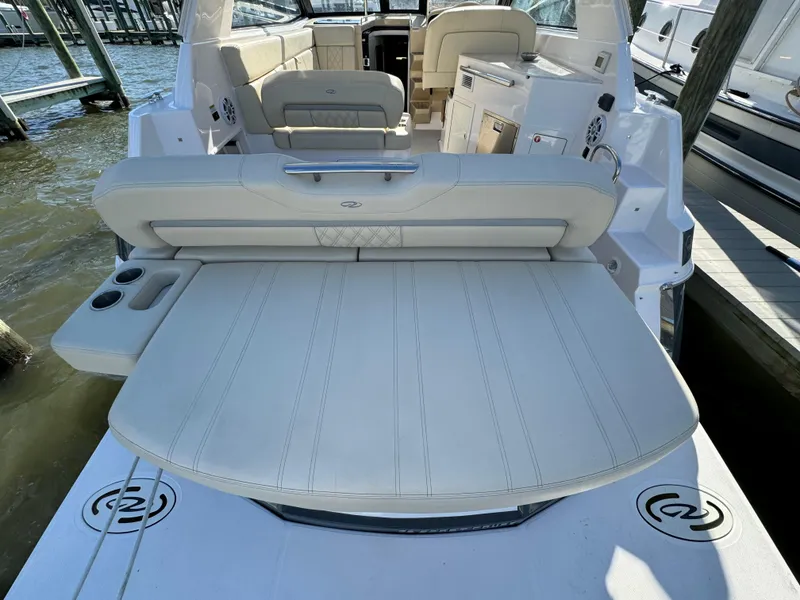 Slide: The Image of 2020 Regal 35 Sport Coupe boat interior with seating and cup holders. - 13