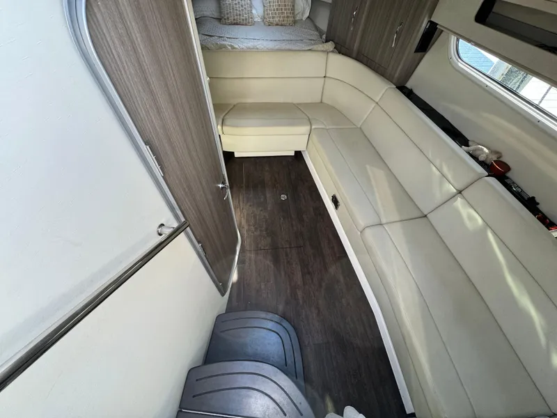 Slide: The Image of Interior of 2020 Regal 35 Sport Coupe with white seating and wood accents. - 14
