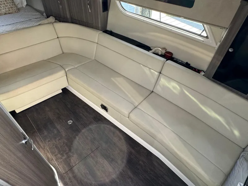 Slide: The Image of Interior of 2020 Regal 35 Sport Coupe with beige leather seating and wood flooring. - 15
