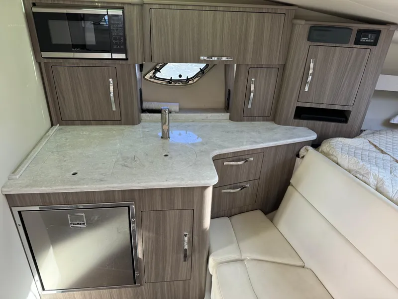 Slide: The Image of 2020 Regal 35 Sport Coupe interior kitchen with modern appliances and sleek cabinetry. - 17