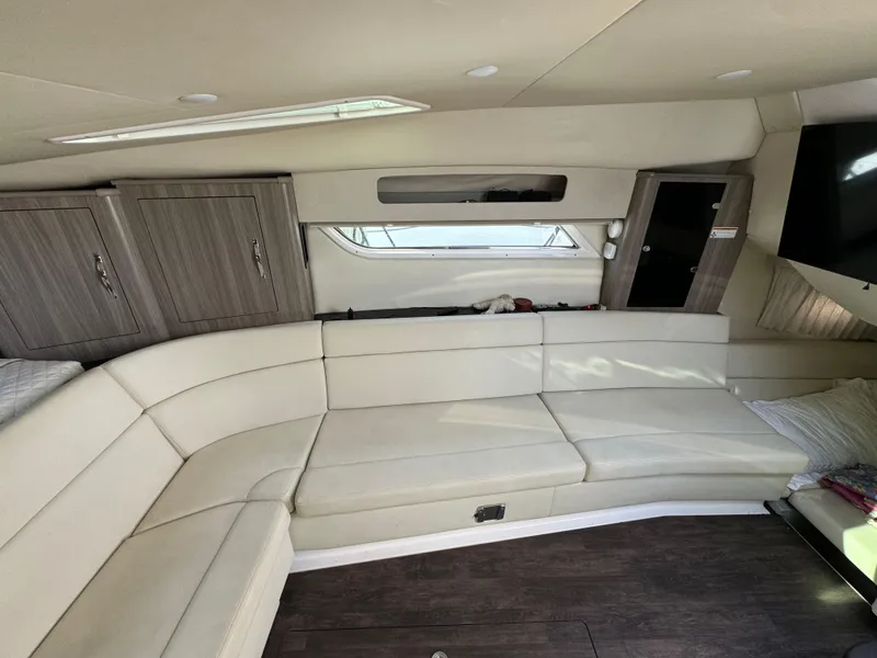 Slide: The Image of 2020 Regal 35 Sport Coupe interior with beige seating and wood cabinets. - 18