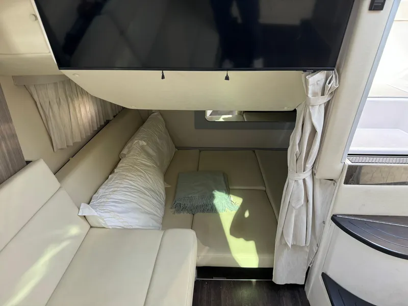 Slide: The Image of Interior of 2020 Regal 35 Sport Coupe with cozy seating and TV. - 19