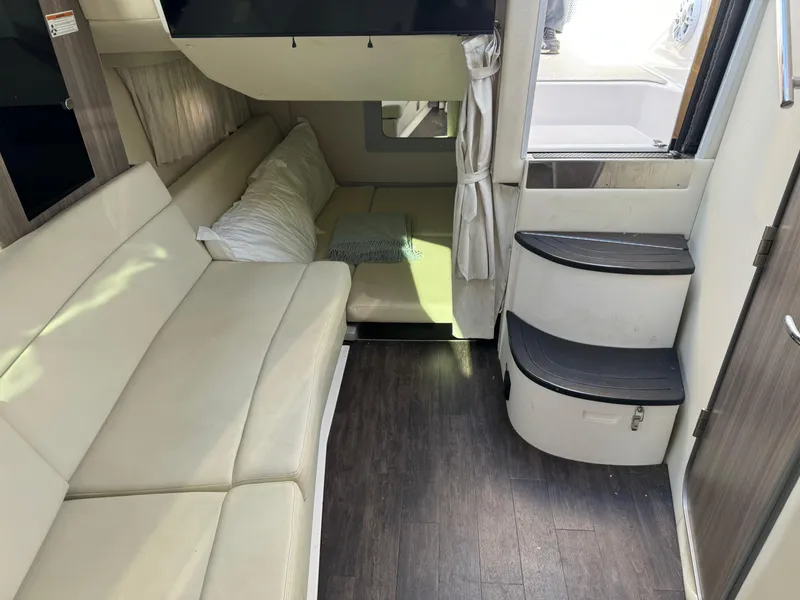 Slide: The Image of Interior of 2020 Regal 35 Sport Coupe with beige seating and wooden flooring. - 20