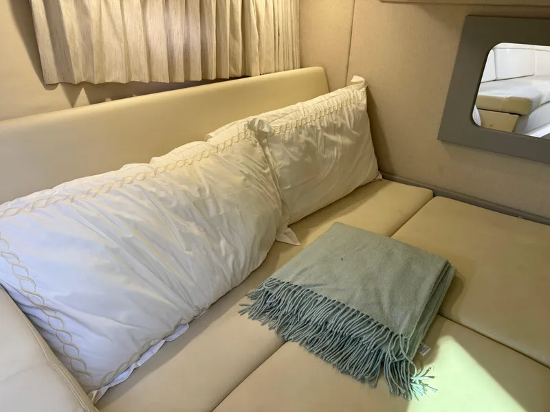 Slide: The Image of Cozy interior of 2020 Regal 35 Sport Coupe with pillows and blanket. - 23