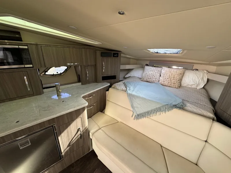 Slide: The Image of 2020 Regal 35 Sport Coupe interior with modern kitchen and cozy sleeping area. - 25