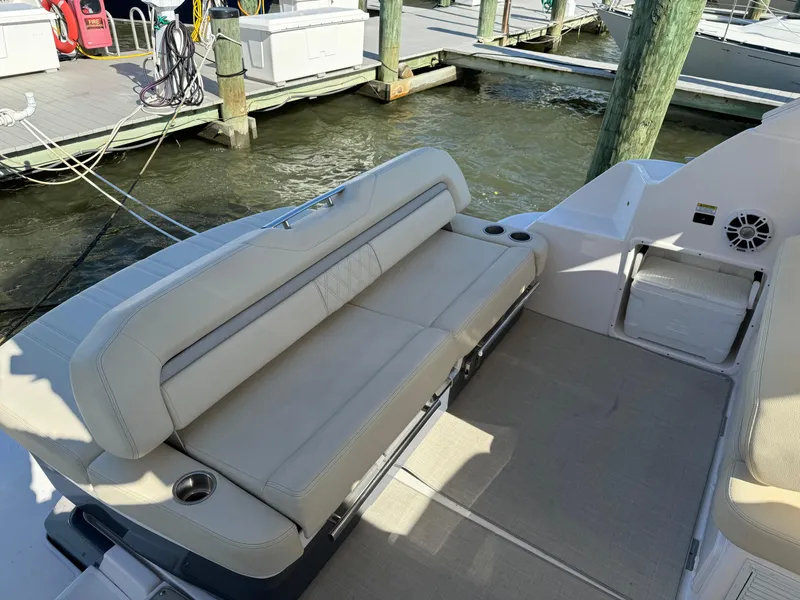 Slide: The Image of 2020 Regal 35 Sport Coupe boat interior with beige seating and cup holders. - 29