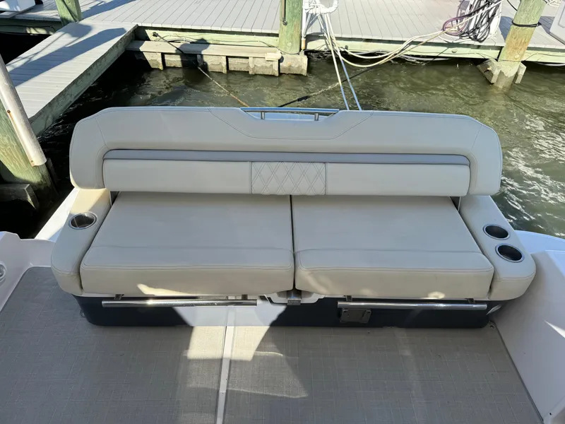 Slide: The Image of 2020 Regal 35 Sport Coupe boat seating with cup holders at dock. - 31