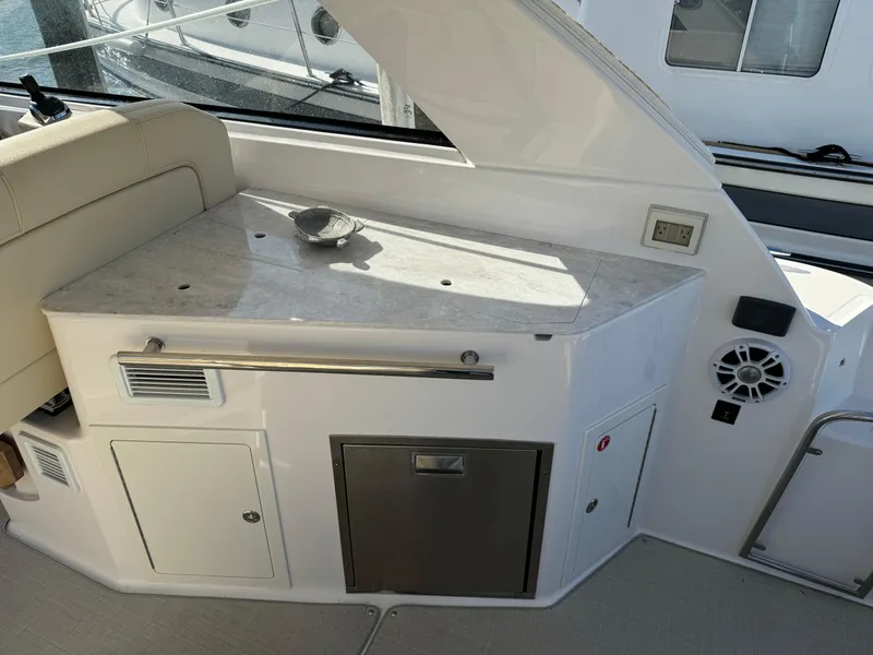 Slide: The Image of 2020 Regal 35 Sport Coupe interior with kitchenette and seating area. - 32