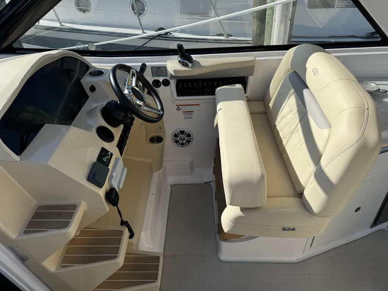 Slide: The Image of 2020 Regal 35 Sport Coupe helm with beige seating and modern controls. - 34
