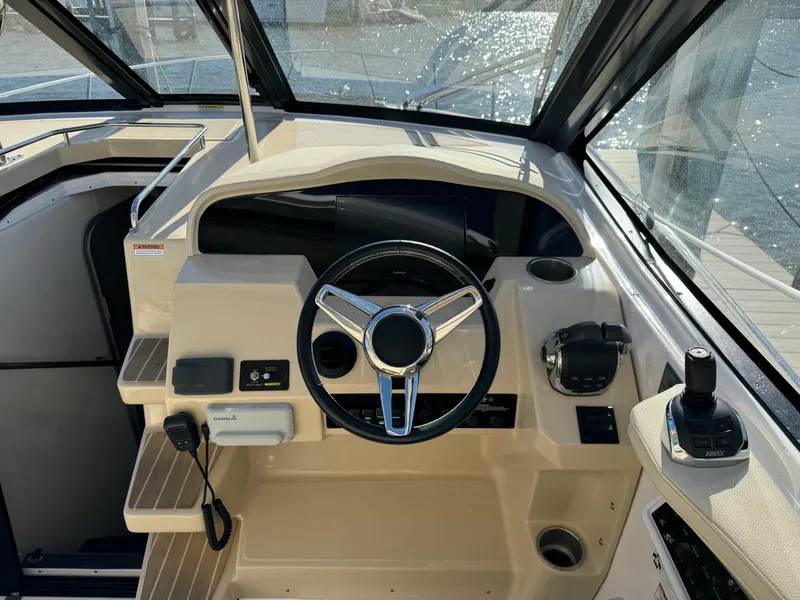 Slide: The Image of 2020 Regal 35 Sport Coupe helm with steering wheel and controls. - 35