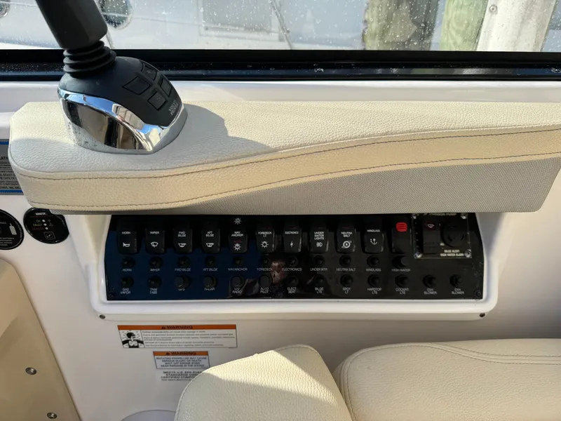 Slide: The Image of Control panel of 2020 Regal 35 Sport Coupe boat with various switches and controls. - 36