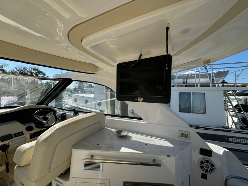 Slide: The Image of Interior of 2020 Regal 35 Sport Coupe with helm and mounted TV. - 40