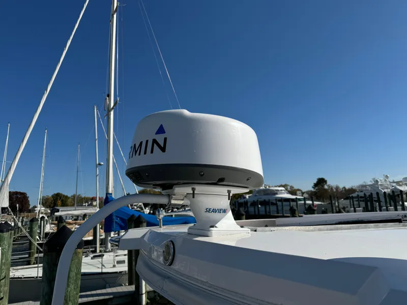 Slide: The Image of Garmin radar on 2020 Regal 35 Sport Coupe boat under clear blue sky. - 45