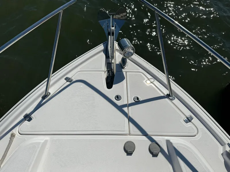 Slide: The Image of Bow of 2020 Regal 35 Sport Coupe on water, featuring anchor and railing. - 46