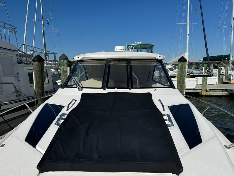 Slide: The Image of 2020 Regal 35 Sport Coupe docked at marina under clear blue sky. - 48