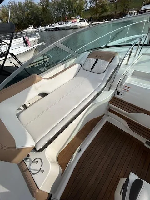 Slide: The Image of 2016 Sea Ray 350 Sundancer boat with sleek seating and wooden deck. - 10