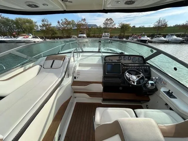 Slide: The Image of 2016 Sea Ray 350 Sundancer cockpit with modern controls and spacious seating. - 12