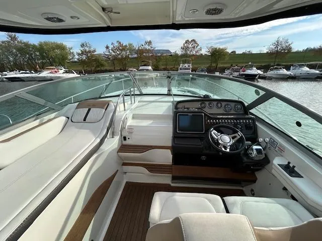 Slide: The Image of 2016 Sea Ray 350 Sundancer cockpit with modern controls and spacious seating. - 13