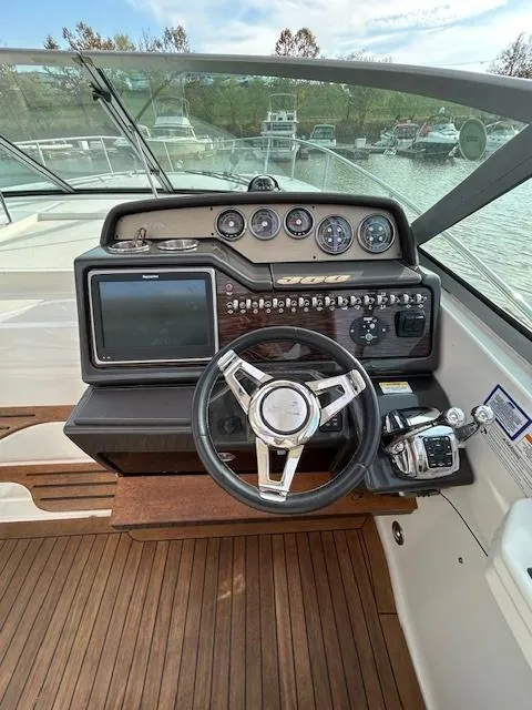 Slide: The Image of 2016 Sea Ray 350 Sundancer helm with modern controls and navigation system. - 14