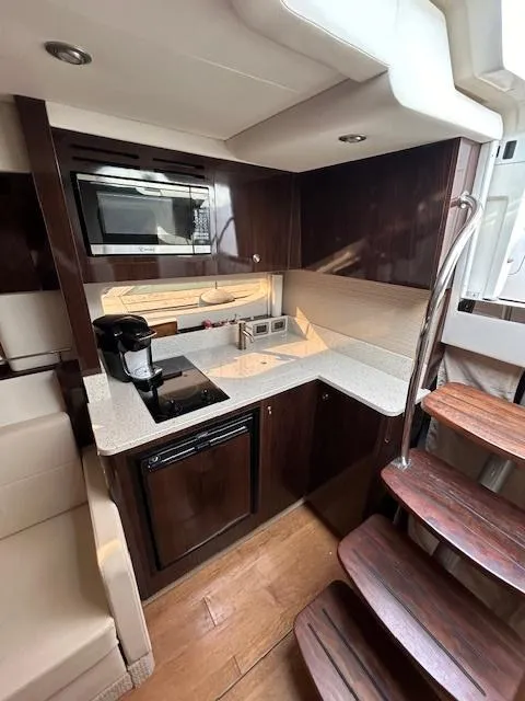 Slide: The Image of Luxurious 2016 Sea Ray 350 Sundancer yacht kitchen with modern appliances and elegant wood finishes. - 18