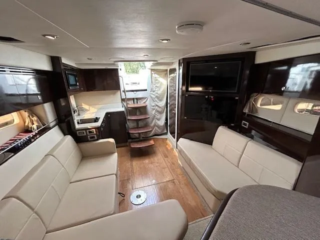 Slide: The Image of Luxurious interior of 2016 Sea Ray 350 Sundancer yacht with modern seating and wood flooring. - 22