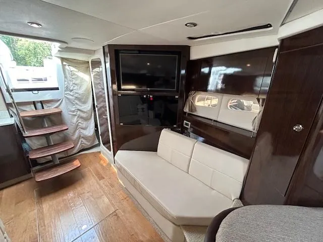 Slide: The Image of Luxurious interior of 2016 Sea Ray 350 Sundancer yacht with TV and seating area. - 23