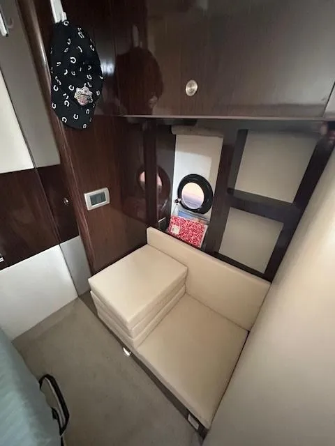 Slide: The Image of 2016 Sea Ray 350 Sundancer cabin interior with seating and storage. - 26