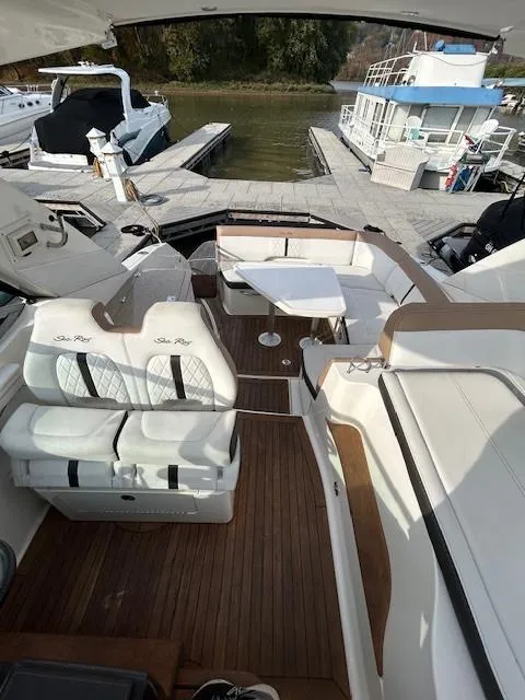 Slide: The Image of 2016 Sea Ray 350 Sundancer yacht interior with seating and table at a marina. - 8