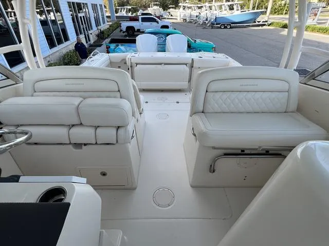 Slide: The Image of 2019 Grady-White Freedom 325 boat interior with white seating and spacious layout. - 15