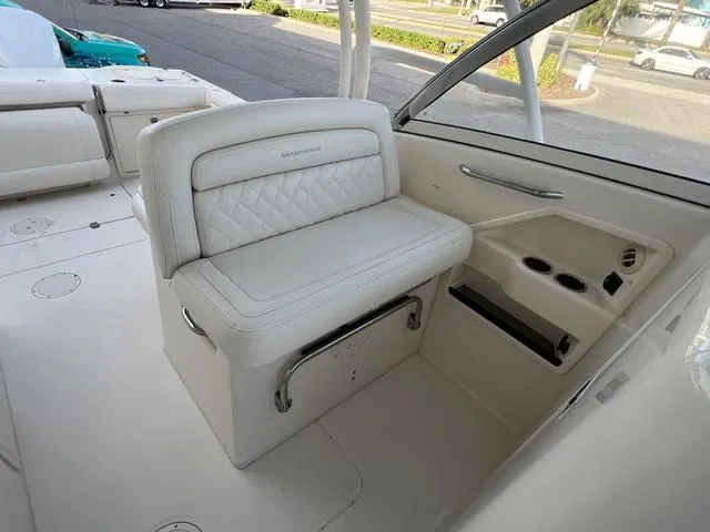 Slide: The Image of 2019 Grady-White Freedom 325 boat interior with white seating and cup holders. - 16