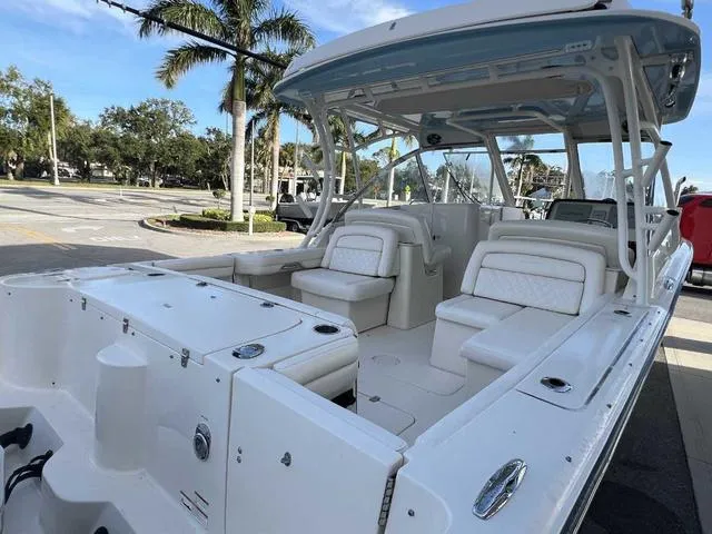 Slide: The Image of 2019 Grady-White Freedom 325 boat interior with white seating and helm. - 26