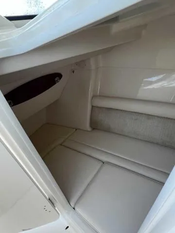 Slide: The Image of 2019 Grady-White Freedom 325 cabin interior with cushioned seating and storage. - 30