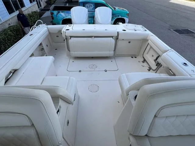 Slide: The Image of 2019 Grady-White Freedom 325 boat interior with white seating and spacious deck. - 33