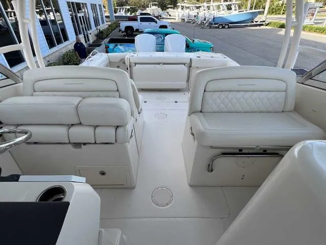 Slide: The Image of 2019 Grady-White Freedom 325 boat interior with white seating and cup holders. - 34