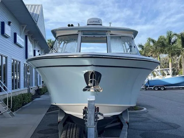Slide: The Image of 2019 Grady-White Freedom 325 boat on trailer, parked under clear blue sky. - 41