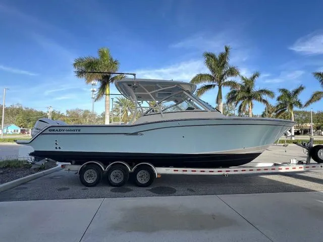 Slide: The Image of 2019 Grady-White Freedom 325 boat with twin Yamaha 300 engines, docked outdoors. - 43