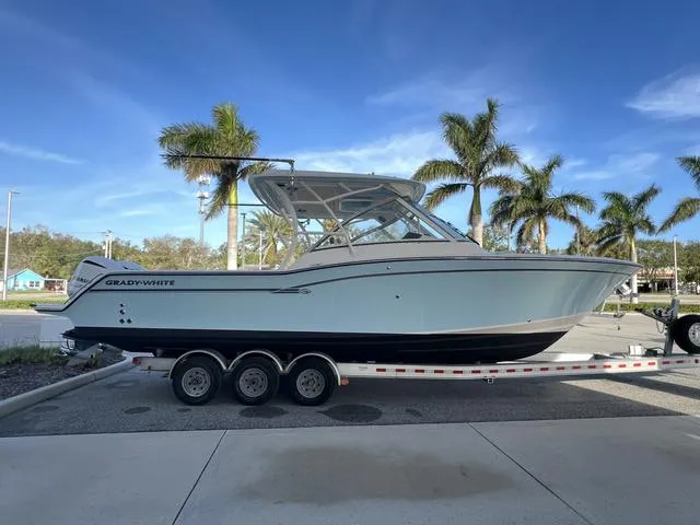 Slide: The Image of 2019 Grady-White Freedom 325 boat on trailer, palm trees in background. - 5